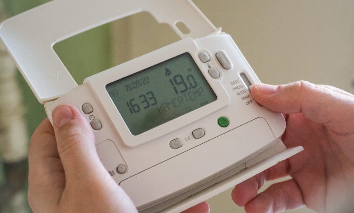 Image of a smart thermostat being adjusted